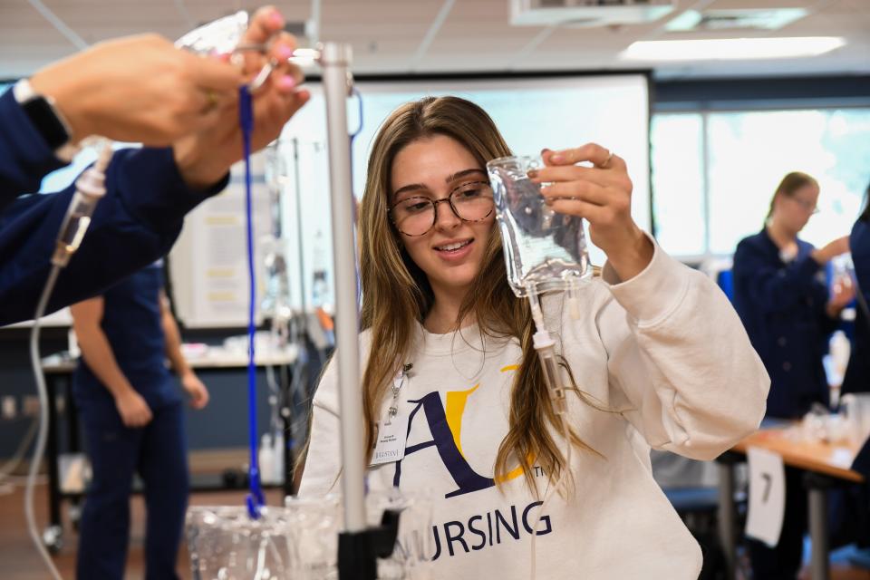 Junior nursing student Brianna Wildermuth practices setting up an infusion set in a classroom on Thursday, Nov. 2, 2023 at Augustana University in Sioux Falls, South Dakota. Students expressed the excitement of being able to learn hands-on experience using nursing tools that get used in the profession.