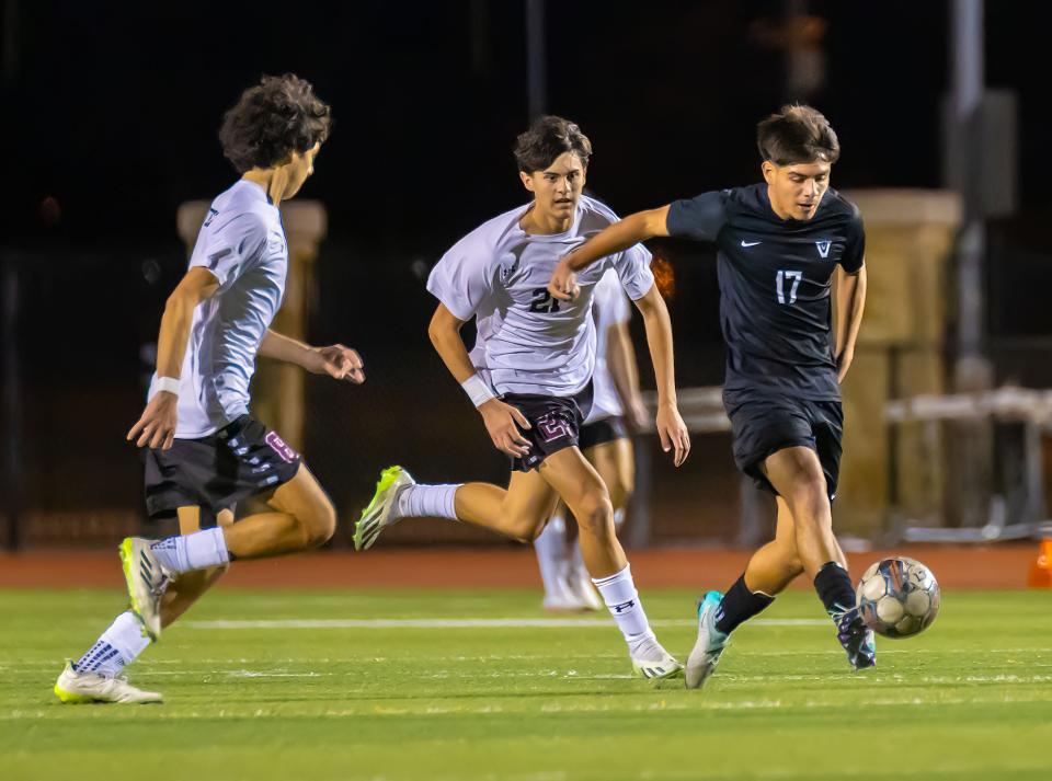 Vandegrift Vipers Yandel Andrade (17) kicks the ball ahead of defending Round Rock Dragons during the second half at the District 25-6A boys soccer game on Tuesday, Jan 30, 2024, at Vandegrift High School in Austin, TX.