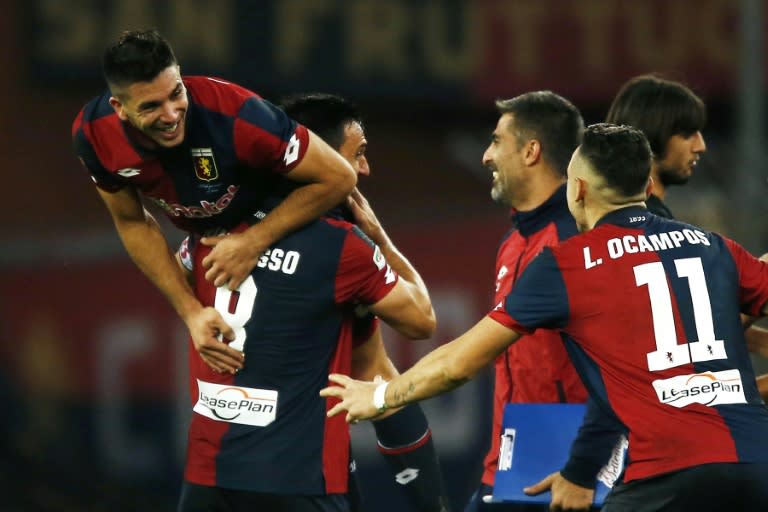 Genoa's forward Giovanni Simeone (L) celebrates with his teammates after scoring