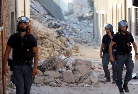 Italian Police patrol along a street following an earthquake in Amatrice, central Italy, August 27, 2016. REUTERS/Ciro De Luca