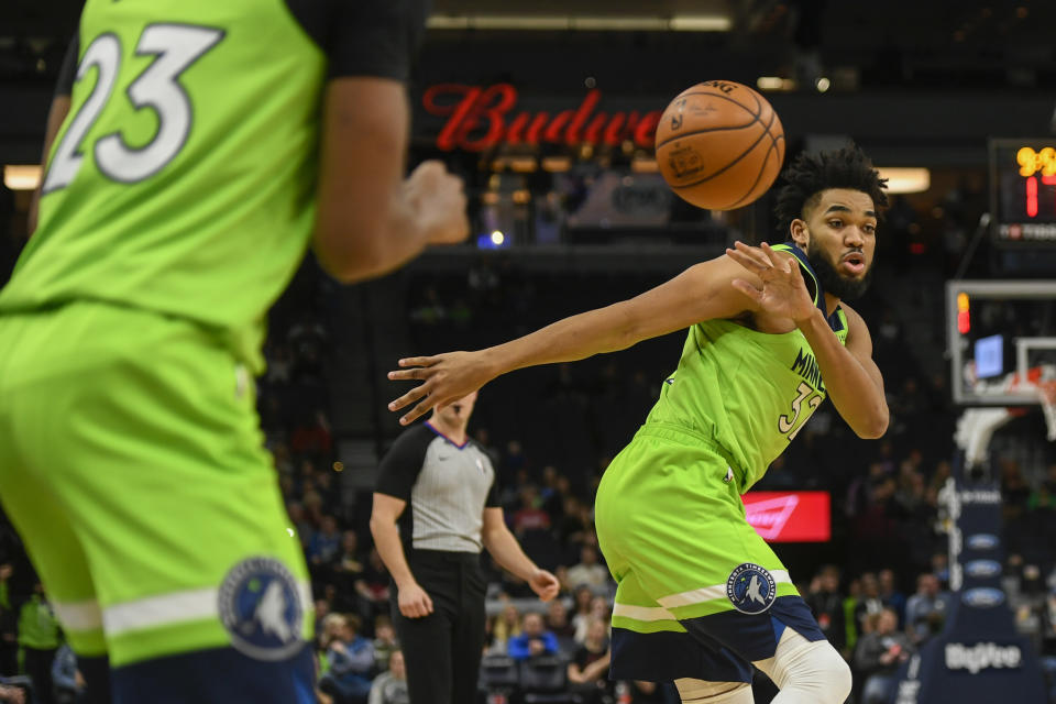 Minnesota Timberwolves center Karl-Anthony Towns, right, passes the ball to Minnesota Timberwolves guard Jarrett Culver during the first half of an NBA basketball game against the Oklahoma City Thunder Saturday, Jan. 25, 2020, in Minneapolis. (AP Photo/Craig Lassig)