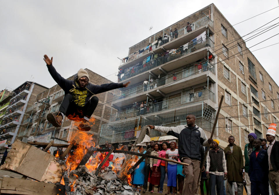 <p>A demonstrator jumps over a barricade set on fire in Mathare, in Nairobi, Kenya, Aug. 9, 2017. (Photo: Thomas Mukoya/Reuters) </p>