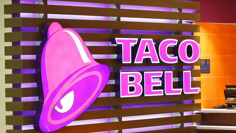 This Friday, April 19, 2019 photo shows a Taco Bell logo at a restaurant in Miami. Taco Bell is adding some new items to its menu.