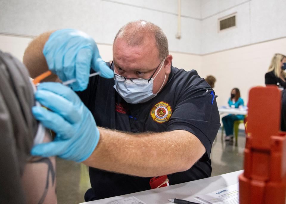 Timothy Davis, a Memphis Fire Department firefighter paramedic, administers the Johnson & Johnson vaccine COVID-19 vaccine to an inmate at the Shelby County Corrections Department in Memphis, Tenn., on Tuesday, Oct. 5, 2021.