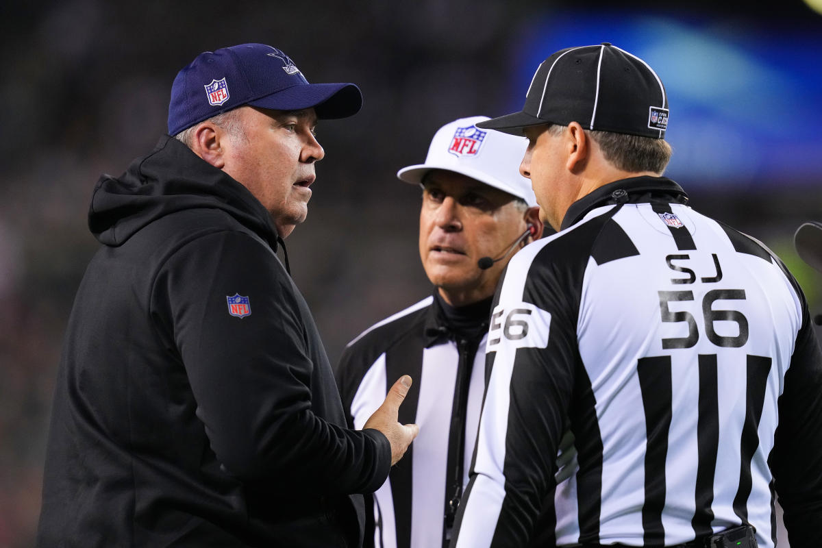 Dallas Cowboys head coach Mike McCarthy talks with line judge Mark