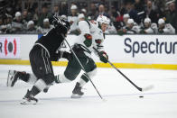 Minnesota Wild left wing Kirill Kaprizov, right, controls the puck past Los Angeles Kings defenseman Mikey Anderson, left, during the first period of an NHL hockey game, Monday, April 15, 2024, in Los Angeles. (AP Photo/Kyusung Gong)