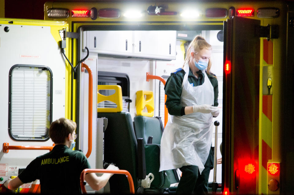 LONDON, ENGLAND - APRIL 07: Ambulance workers transport patients outside St Thomas Hospital in Westminster, where British Prime Minister Boris Johnson has now been transferred to the ICU after showing persistent symptoms of coronavirus COVID-19 for 10 days, on April 7, 2020 in London, United Kingdom.  At 7pm last night an announcement was made that the Prime Minister had been moved to intensive care after his symptoms worsened. The country is in its third week of lockdown measures aimed at slowing the spread of the virus with people urged to stay at home and only leave the house for basic food shopping, exercise once a day and essential travel to and from work. There have been around 60,000 reported cases of the COVID-19 coronavirus in the United Kingdom and over 5,000 deaths. (Photo by Ollie Millington/Getty Images)