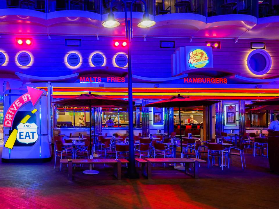 The outside of a Johnny Rockets on a cruise ship at night