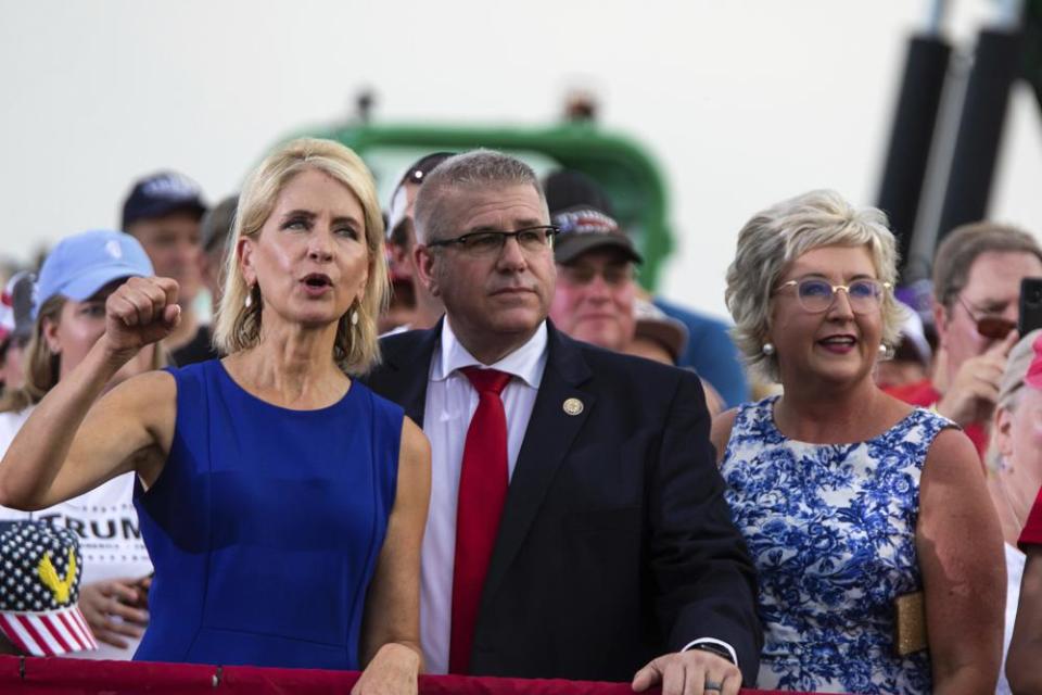 U.S. Rep. Mary Miller, of Illinois, left, cheers next to Illinois state Sen. Darren Bailey at a rally where former President Donald Trump spoke, at the Adams County Fairgrounds in Mendon, Ill., Saturday, June 25, 2022. (Mike Sorensen/Quincy Herald-Whig via AP)