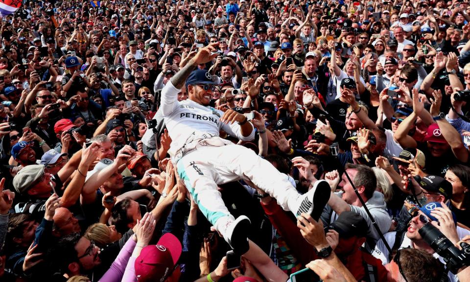 <span>Lewis Hamilton celebrates his victory with the crowd after winning the 2016 British Grand Prix.</span><span>Photograph: David Davies/PA</span>