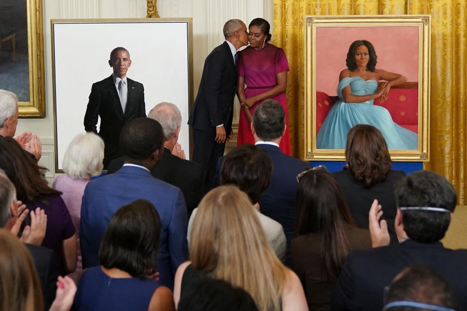 Former President Barack Obama kisses his wife, former first lady Michelle Obama, during a ceremony to unveil their official White House portraits, in the East Room of the White House on Sept. 7.