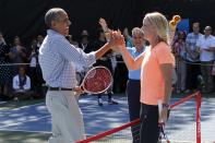 U.S. President Barack Obama (L) reacts to hitting a winner down the line against a tough volley from tennis player Caroline Wozniacki (R), one of the activities at the annual Easter Egg Roll at the White House in Washington April 6, 2015. REUTERS/Jonathan Ernst