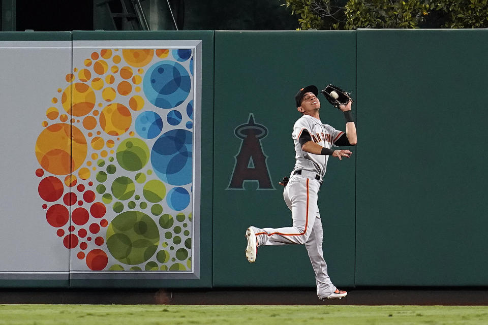 San Francisco Giants centerfielder Mauricio Dubon makes a catch on a line drive from Los Angeles Angels' Luis Rengifo during the seventh inning of a baseball game Tuesday, June 22, 2021, in Anaheim, Calif. (AP Photo/Marcio Jose Sanchez)