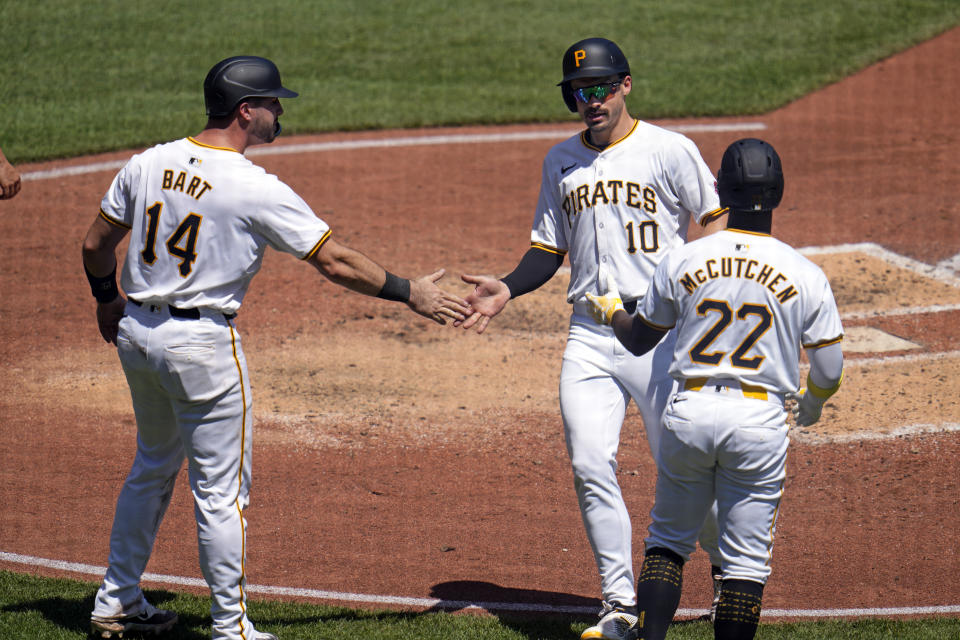 Pittsburgh Pirates' Bryan Reynolds (10) is greeted by Joey Bart (14) and Andrew McCutchen after all three scored on a double by Oneil Cruz off Los Angeles Angels starting pitcher José Soriano during the fifth inning of a baseball game in Pittsburgh, Wednesday, May 8, 2024. (AP Photo/Gene J. Puskar)