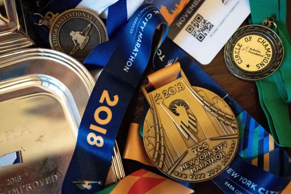 Brian Lilly Jr.'s New York City Marathon medal is displayed in Brenda and Brian Lilly's home, Thursday, Oct. 13, 2022, in Easton, Conn. Brian Lilly Jr., 19, who committed suicide on Jan. 4, 2021, was a rower at University of California San Diego. The Lillys have filed a wrongful death lawsuit against the university and the rowing coach, Geoff Bond, who is no longer with the school. (AP Photo/Julia Nikhinson)