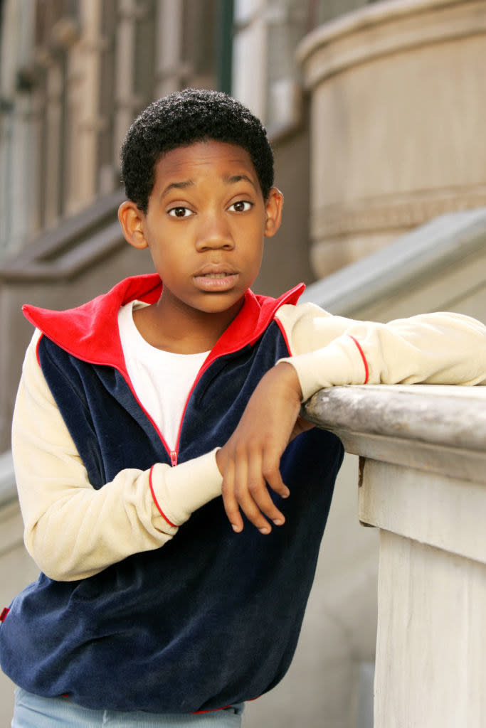 Close-up of Tyler as a boy leaning on a stoop banister