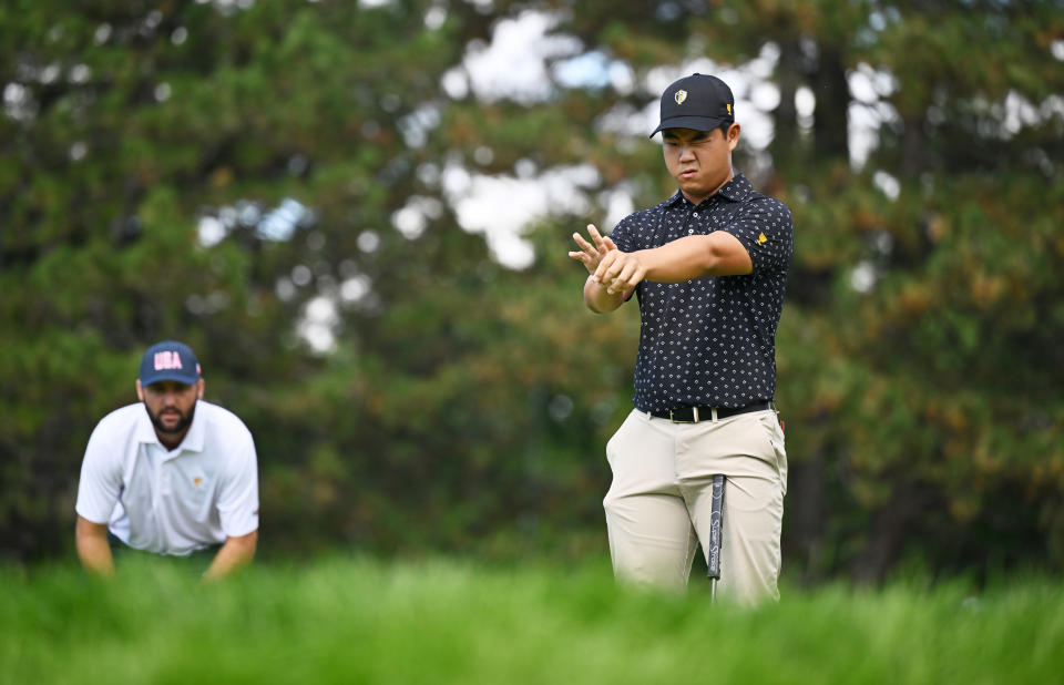 Tom Kim (right) found out what happens when you taunt Scottie Scheffler. (Minas Panagiotakis/Getty Images)