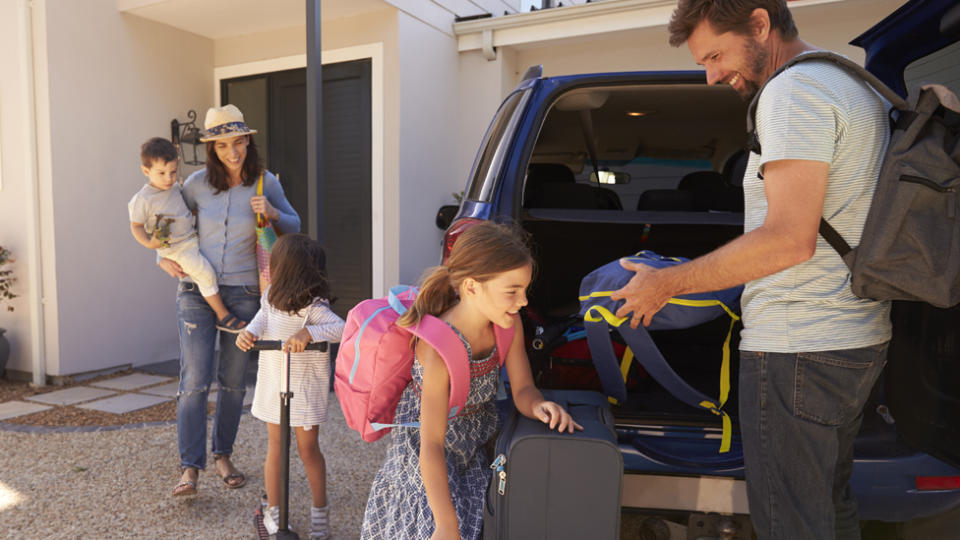 A family packing a car for a road trip