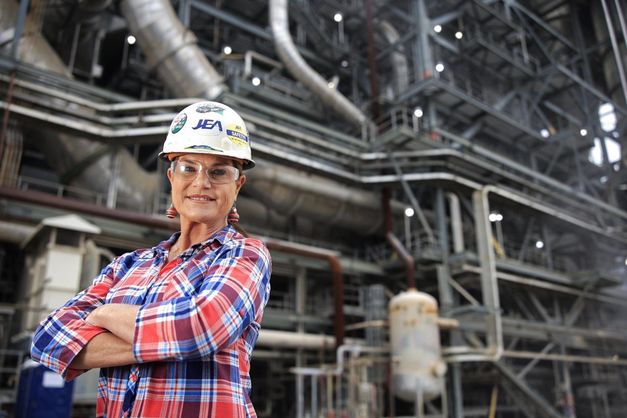 Margaret Limbaugh, director of electric production for JEA at the Northside Generating Station, stands in front of the power plant. She is the first woman to be a director at one of JEA's generating stations.