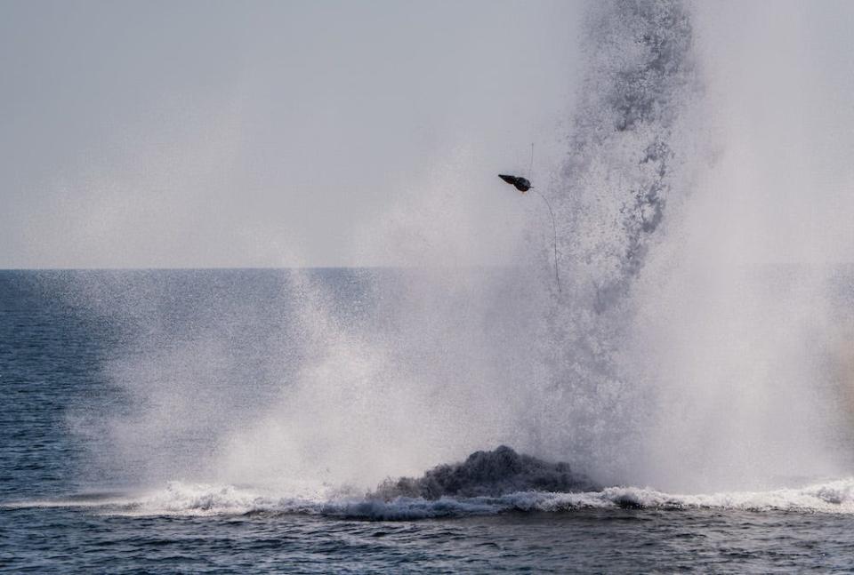 A plume of water and some debris shoot out of the Black Sea off the coast of Burgas, Bulgaria, on July 22 2022 during military mine countermeasures exercise Sea Breeze.