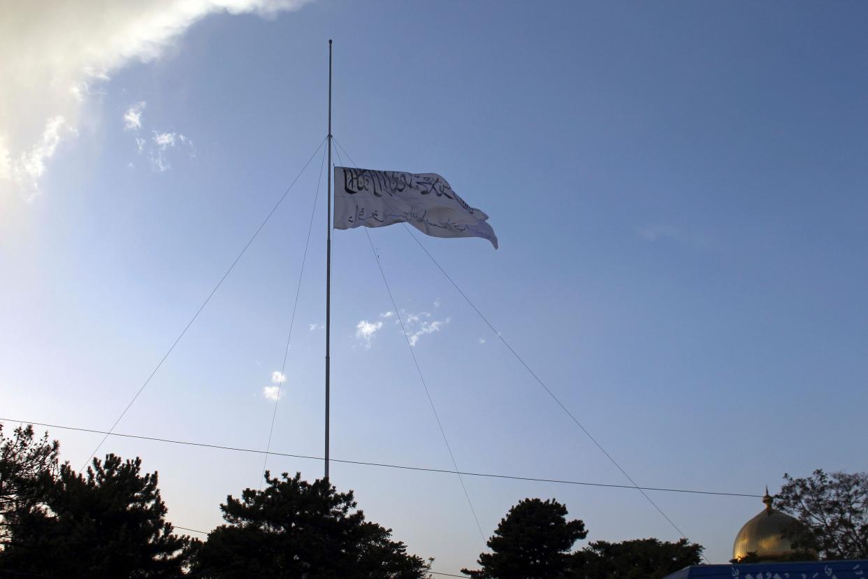 The Taliban flag flies at the Ghazni provincial governor's house in Ghazni, southeastern, Afghanistan on Sunday, Aug. 15, 2021.