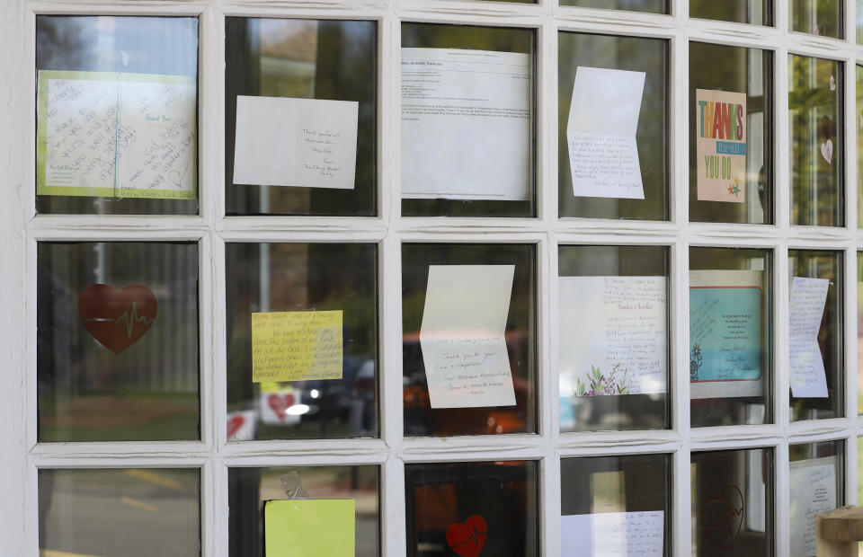 Notes for healthcare workers hang in the front window at the Kimberly Hall North nursing home, Thursday, May 14, 2020 in Windsor, Conn. The coronavirus has had no regard for health care quality or ratings as it has swept through nursing homes around the world, killing efficiently even in highly rated care centers. Preliminary research indicates the numbers of nursing home residents testing positive for the coronavirus and dying from COVID-19 are linked to location and population density — not care quality ratings. (AP Photo/Chris Ehrmann)