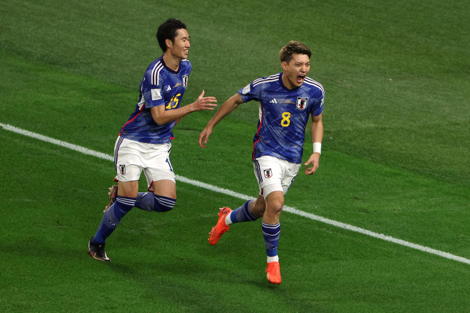DOHA, QATAR - NOVEMBER 23: Ritsu Doan (R) of Japan celebrates with Daichi Kamada after scoring their team's first goal during the FIFA World Cup Qatar 2022 Group E match between Germany and Japan at Khalifa International Stadium on November 23, 2022 in Doha, Qatar. (Photo by Dean Mouhtaropoulos/Getty Images)