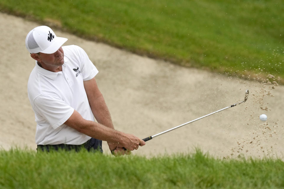 Lucas Glover hits out of a bunker on the 18th green during the final round of the John Deere Classic golf tournament, Sunday, July 11, 2021, at TPC Deere Run in Silvis, Ill. (AP Photo/Charlie Neibergall)