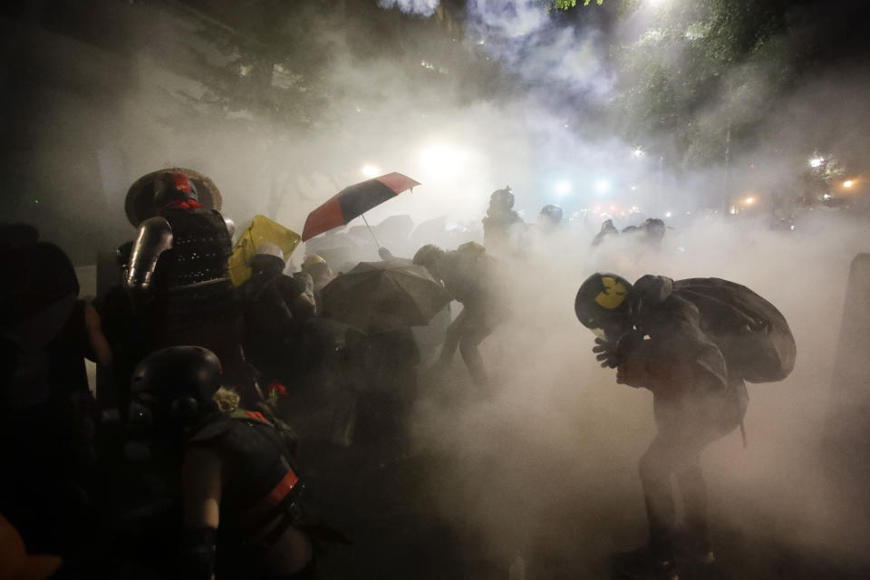 FILE - In this July 26, 2020, file photo, federal officers launch tear gas at a group of demonstrators during a Black Lives Matter protest at the Mark O. Hatfield United States Courthouse in Portland, Ore. An Associated Press analysis of more than 200 arrests shows that even those accused of breaking the law during the nightly rallies don’t neatly fit into President Donald Trump’s depiction of protesters as “anarchists and agitators.” (AP Photo/Marcio Jose Sanchez, File)