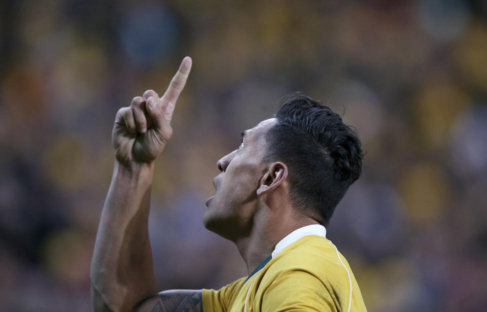 In this June 25, 2016, photo Australian rugby union player Israel Folau points to the sky after scoring a try against England during their rugby union test match in Sydney. Folau, one of the sport's top players, published a message on his Instagram account that said "drunks, homosexuals, adulterers, liars, fornicators, thieves, atheists, idolators. Hell awaits you." (AP Photo/Rick Rycroft)
