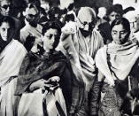 Photograph of Mahatma Gandhi being supported by his granddaughters. (Photo by: Universal History Archive/Universal Images Group via Getty Images)