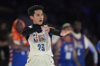 Actor Dylan Wang reacts after hitting a 3-point shot during the second half of the NBA basketball All-Star Celebrity Game, Friday, Feb. 16, 2024, in Indianapolis. (AP Photo/Darron Cummings)