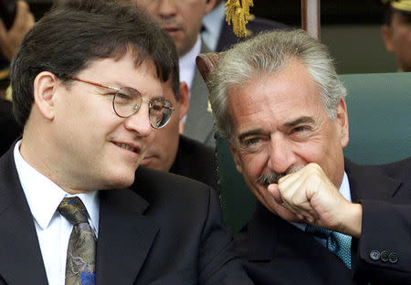 FILE PHOTO: Colombian President Andres Pastrana (R) talks with Defense Minister Gustavo Bell during a ceremony at a military school in Bogota, Colombia April 23, 2002. REUTERS/Eliana Aponte/File Photo