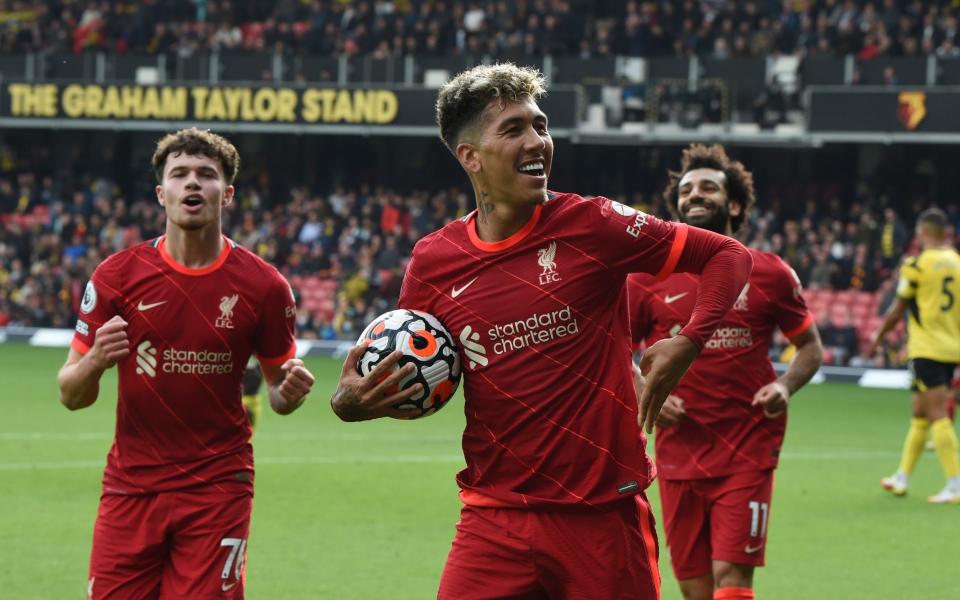 Roberto Firmino of Liverpool scores the fifth goal making the score and makes it his hat-trick during the Premier League match between Watford and Liverpool a - Getty Images