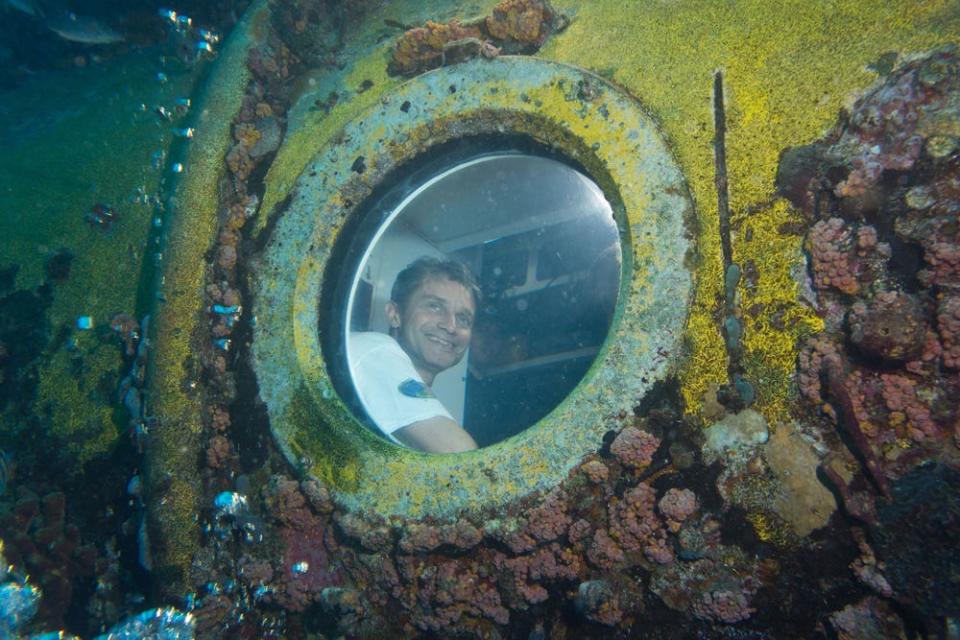 Ocean explorer Fabien Cousteau looks out of the window of NOAA's Aquarius research station in 2014. The station is operated in the Florida Keys by Florida International University.