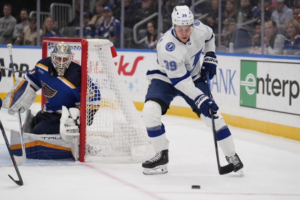 Tampa Bay Lightning's Waltteri Merela (39) handles the puck as St. Louis Blues goaltender Jordan Binnington (50) defends during the first period of an NHL hockey game Tuesday, Nov. 14, 2023, in St. Louis. (AP Photo/Jeff Roberson)