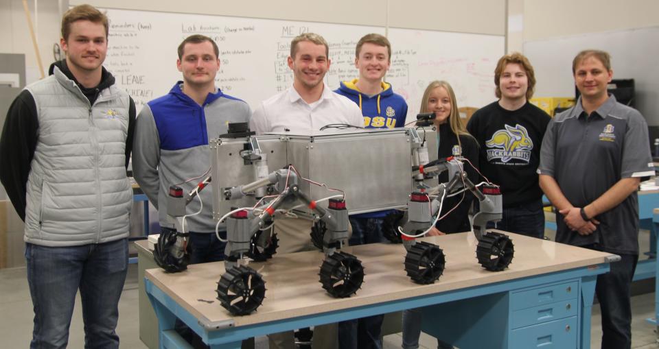 The SDSU team competing in the RASC-AL NASA contest pose with a prototype of a rover designed to explore rugged, frozen lunar craters. From left to right: Braxton McGrath, Aiden Carstensen, graduate adviser Liam Murray, Dylan Stephens, Delaney Baumberger, Alex Schaar and faculty adviser Todd Letcher.