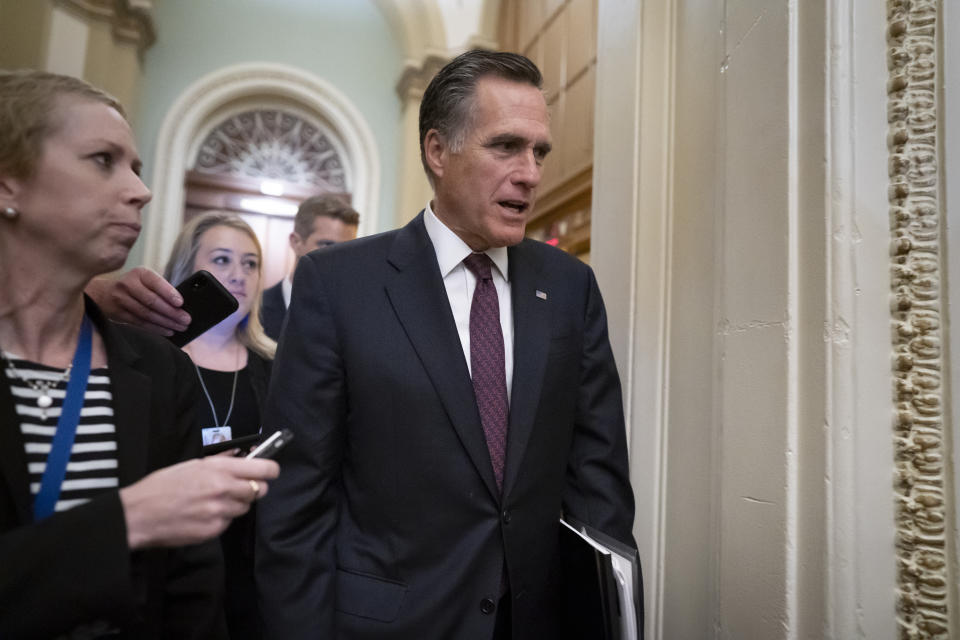 Sen. Mitt Romney, R-Utah, arrives as defense arguments by the Republicans resume in the impeachment trial of President Donald Trump on charges of abuse of power and obstruction of Congress, at the Capitol in Washington, Tuesday, Jan. 28, 2020. (AP Photo/J. Scott Applewhite)