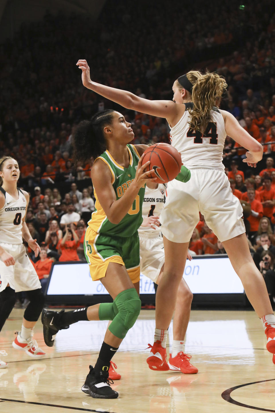 Oregon's Satou Sabally (0) darts behind Oregon State's Taylor Jones (44) to shoot to the basket during the first half of an NCAA college basketball game in Corvallis, Ore., Sunday, Jan. 26, 2020. (AP Photo/Amanda Loman)