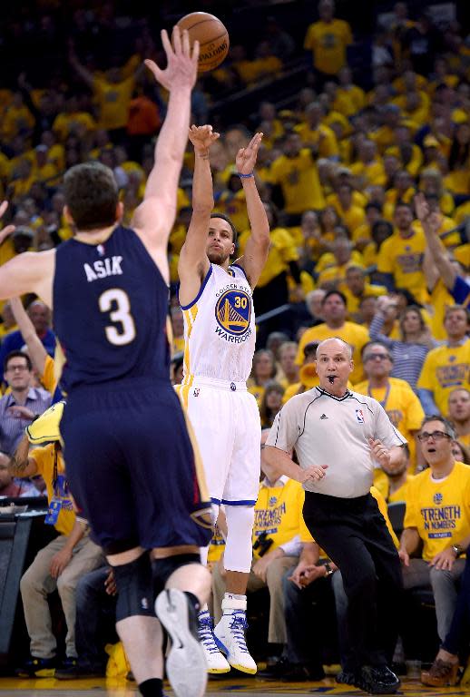 Golden State Warriors' Stephen Curry shoots over New Orleans Pelicans' Omer Asik during the first round of the NBA Playoffs at ORACLE Arena on April 20, 2015