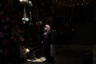 A Palestinian woman passes through Damascus Gate to leave the Old City of Jerusalem after Friday prayers during the Muslim holy month of Ramadan, on Friday, April 23, 2021. Israeli police say 44 people were arrested and 20 officers were wounded in a night of chaos in Jerusalem, where security forces separately clashed with Palestinians angry about Ramadan restrictions and Jewish extremists who held an anti-Arab march nearby. (AP Photo/Maya Alleruzzo)