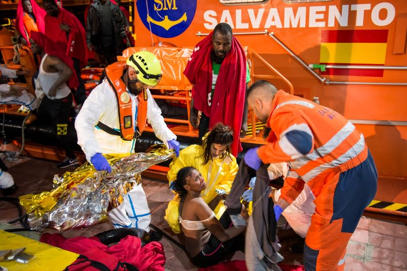 Spanish coast guards help migrants disembark the ship after dozens of them were rescued in a raft off the coast at the Mediterranean Sea, at the port of the Spanish North African enclave of Melilla