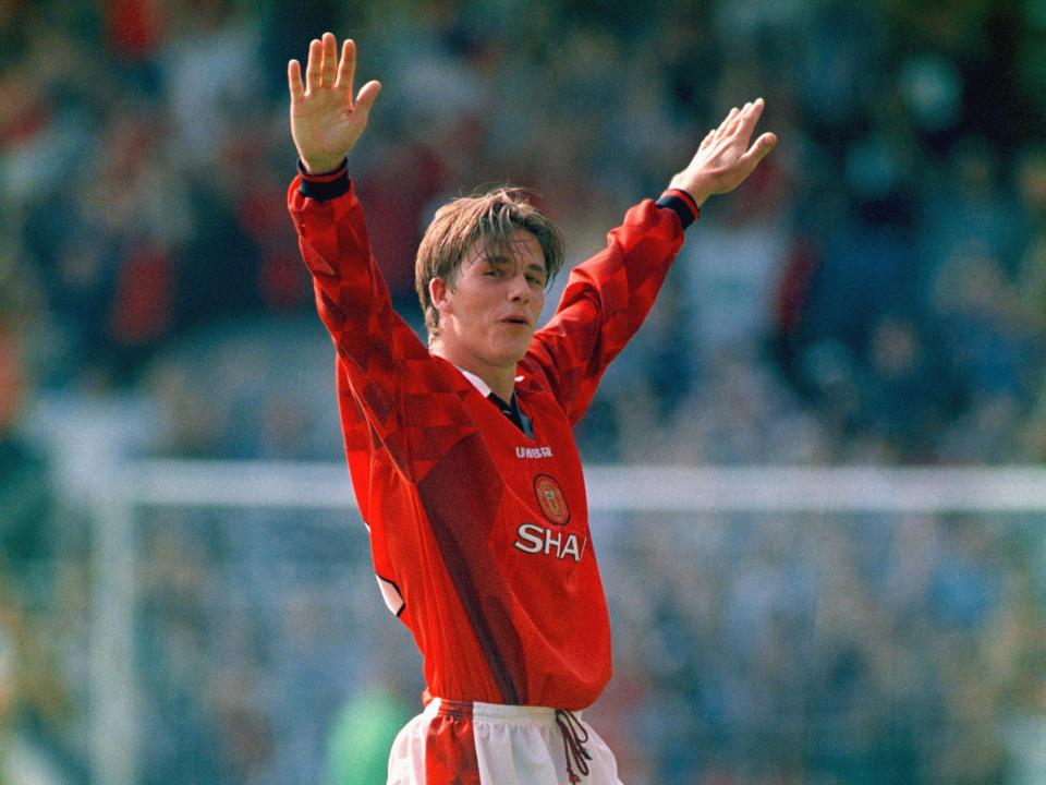 Manchester United player David Beckham celebrates after scoring the third goal with a spectacular effort from the halfway line, during the Premier League match between Wimbledon and Manchester United at Selhurst Park on August 17, 1996 in London, England.