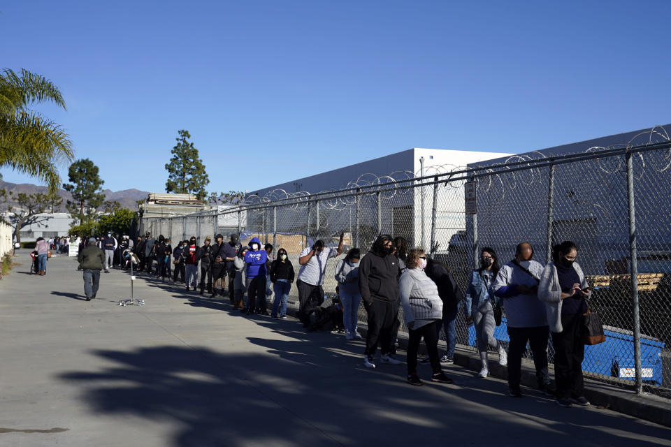 People line up at a COVID-19 testing center Wednesday, Jan. 5, 2022, in San Fernando, Calif. (AP Photo/Marcio Jose Sanchez)