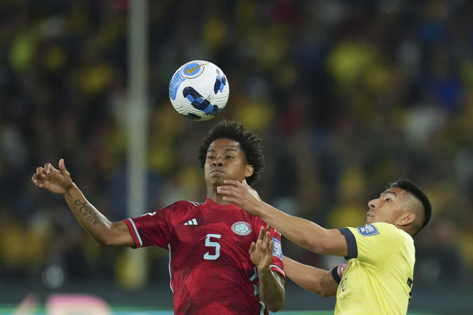 Colombia's Wilmar Barrios, left, and Ecuador's Angel Mena, battle for the ball during a qualifying soccer match for the FIFA World Cup 2026 at the Rodrigo Paz Delgado stadium in Quito, Ecuador, Tuesday, Oct. 17, 2023. (AP Photo/Dolores Ochoa)