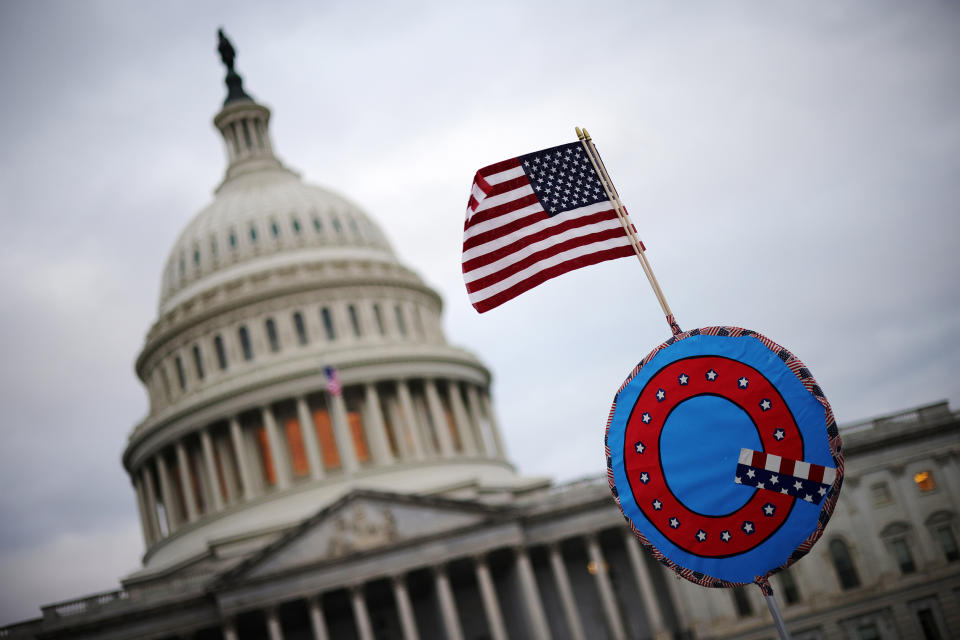 Image: A U.S. flag with a symbol from the group QAnon outside the U.S. Capitol on Jan. 6, 2021. (Win McNamee / Getty Images file)