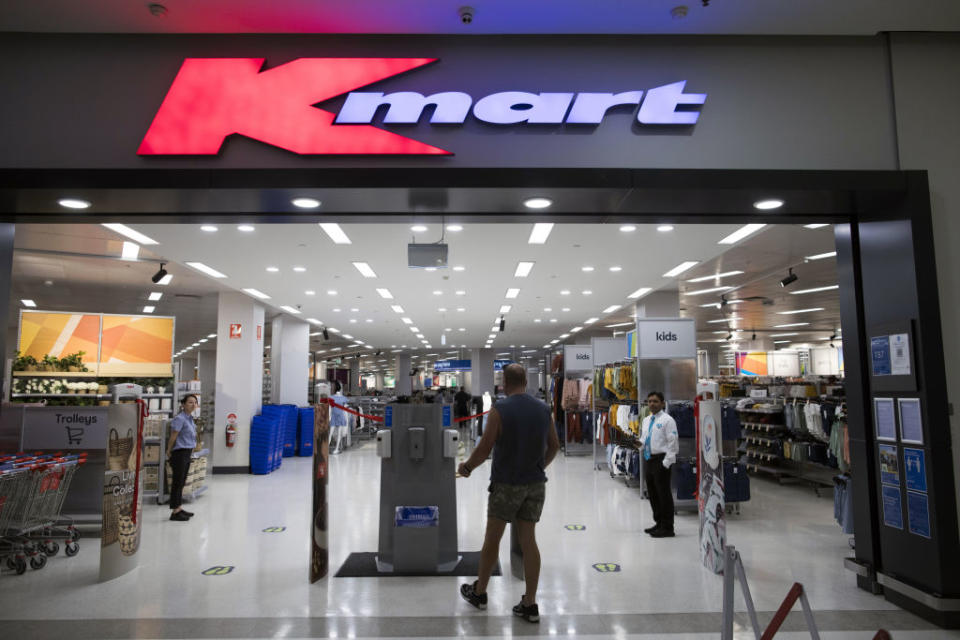 A customer walks toward a hand sanitiser dispenser at a Kmart store in Sydney. Source: Getty