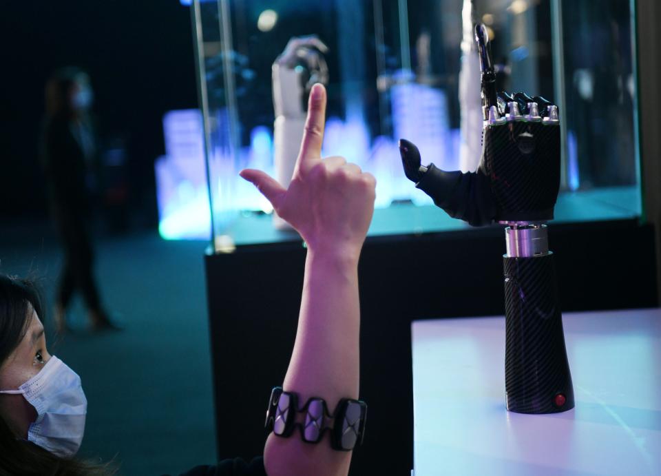 BEIJING, Nov. 25, 2020 -- An employee demonstrates a wearable AI-powered bionic hand at the JD Global Technology Discovery Conference in Beijing, capital of China, Nov. 25, 2020. The conference, sponsored by JD.com, a leading e-commerce platform in China, kicked off here on Wednesday under the theme of 