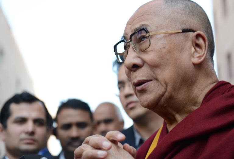 Tibetan spiritual leader The Dalai Lama speaks about Nelson Mandela as he attends a function in New Delhi on December 6, 2013