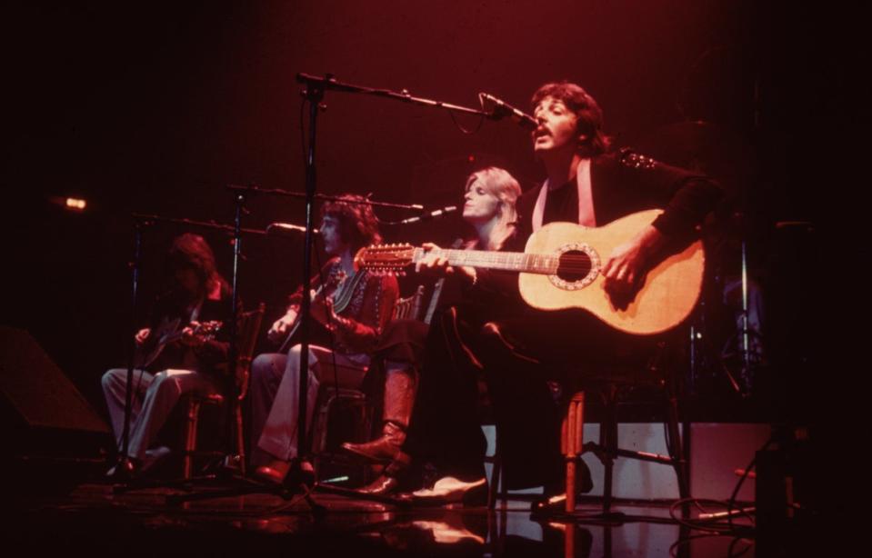 Paul McCartney on stage with his wife, Linda McCartney (1941-1998) as Wings perform at London’s Empire Pool in 1976 (Getty Images)